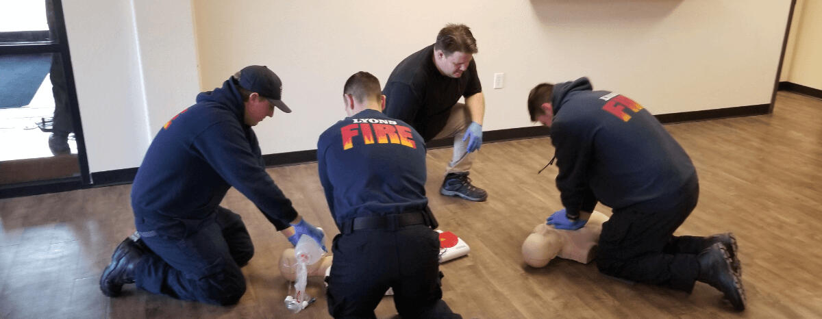 Keith Ryen, AHA Instructor near Victoria, TX, training three firefighters to perform CPR. Keith teaches classes for certification in CPR, BLS, First Aid, and more.