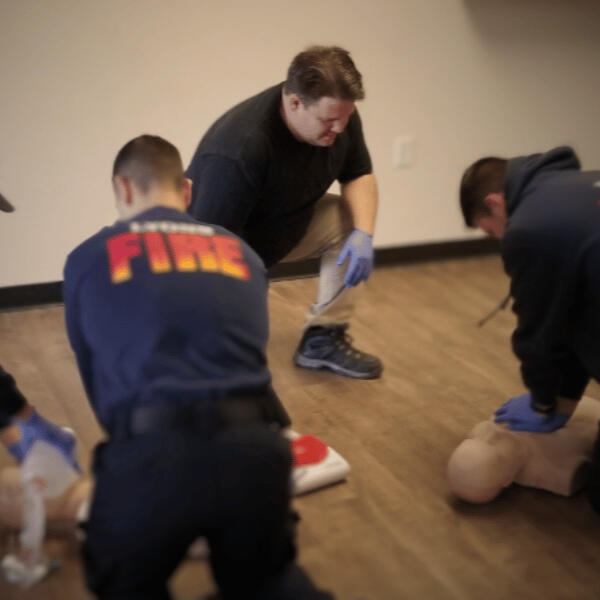 Keith Ryen, AHA Instructor near Victoria, TX, training three firefighters to perform CPR. Keith teaches classes for certification in CPR, BLS, First Aid, and more.